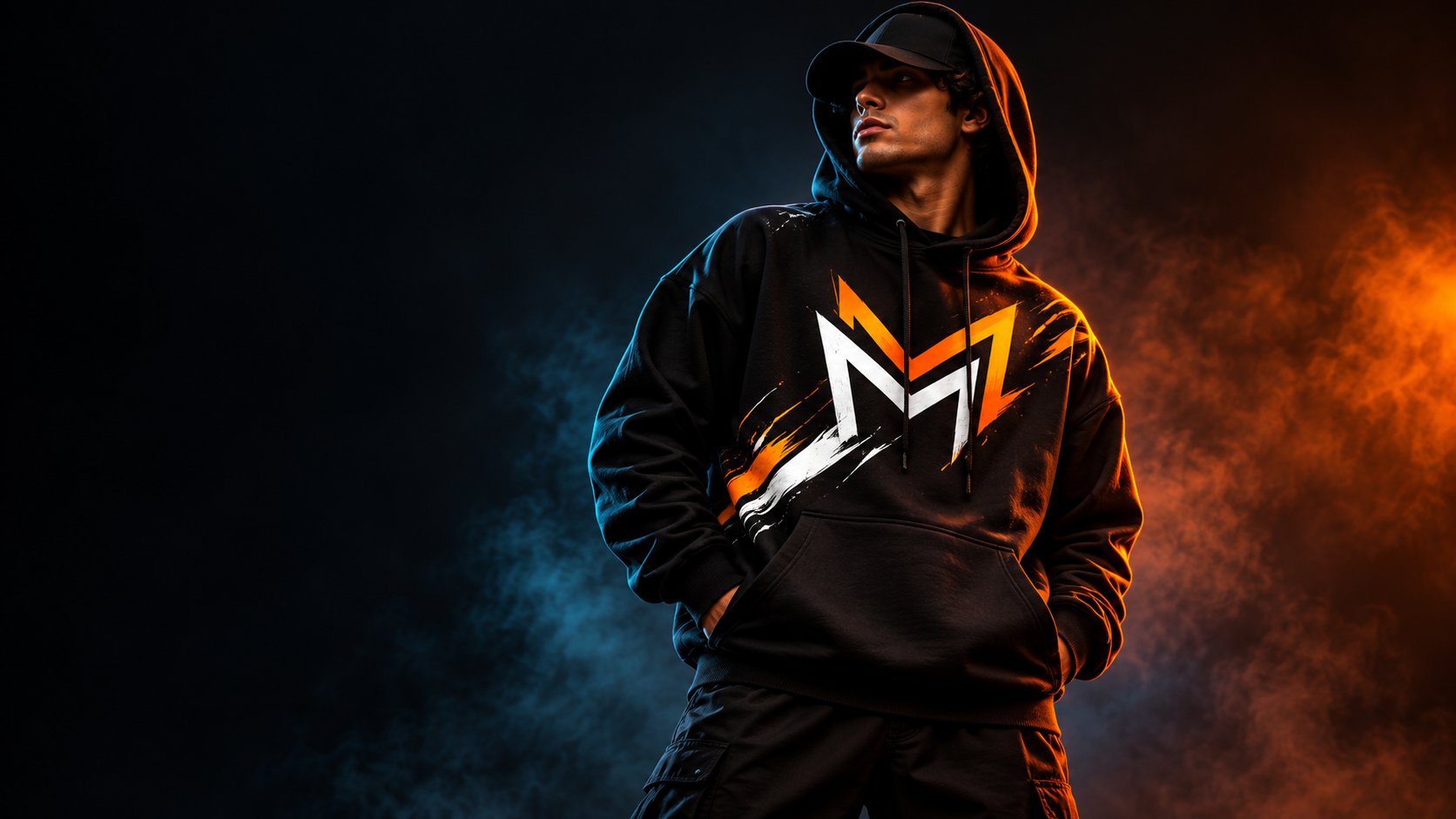 Model in a black graphic hoodie lit with orange and blue light